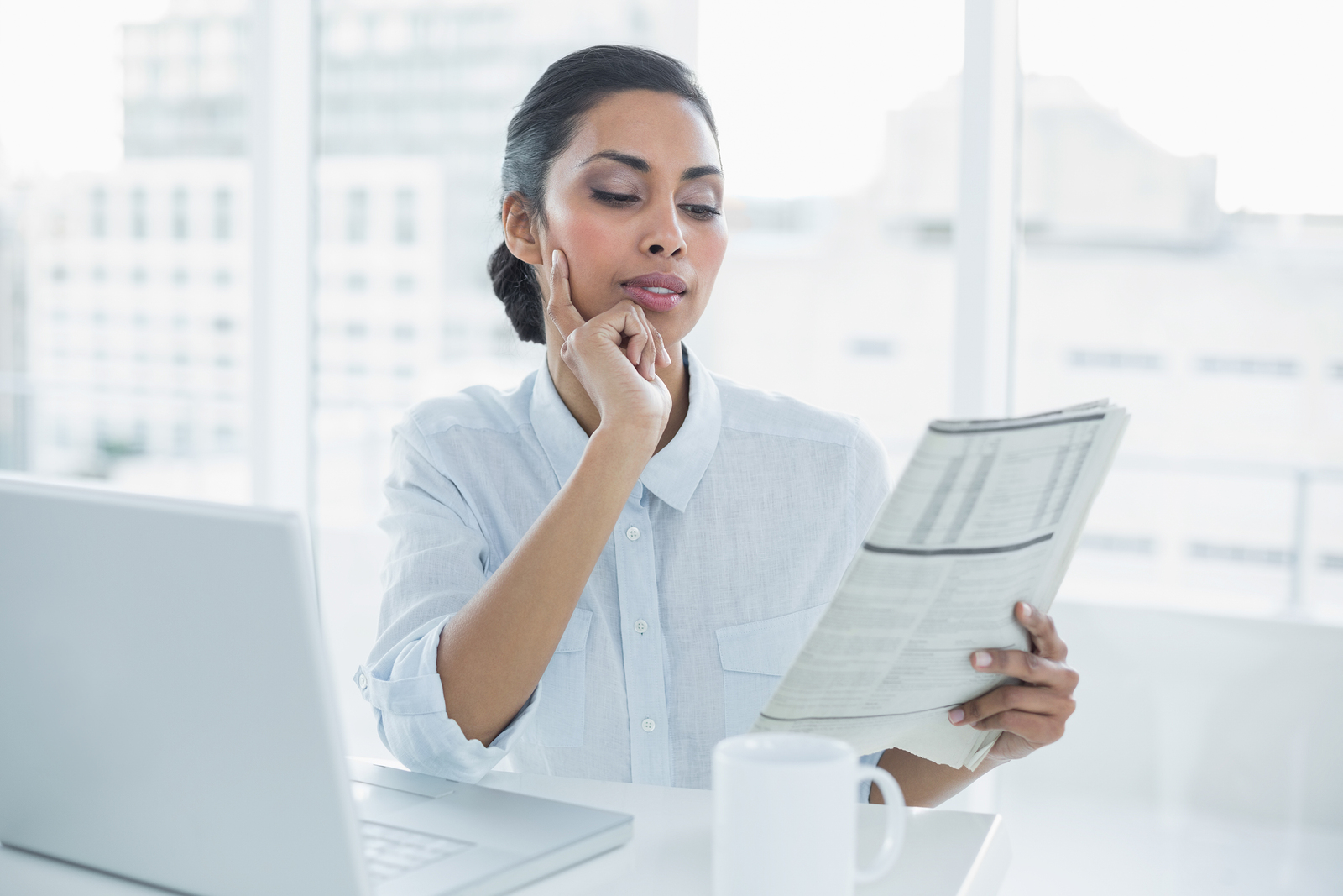 Woman focus. Женщина читает газету. Is this her Desk?.